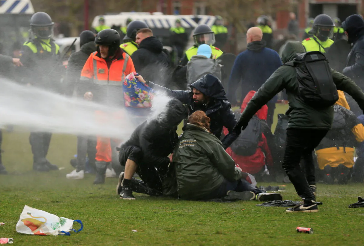 Police uses a water canon during a protest against COVID-19 restrictions, in Amsterdam, Netherlands, on Jan. 24, 2021. (Eva Plevier/Reuters)