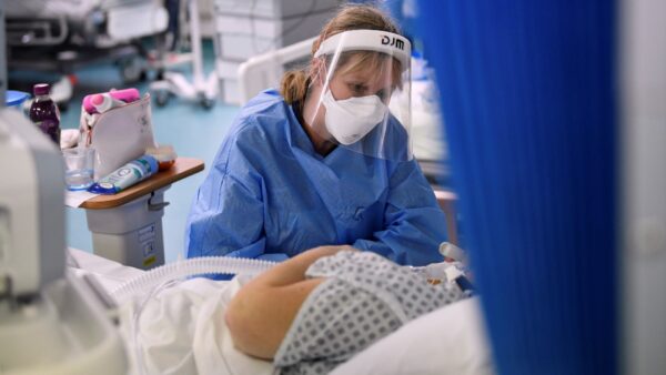 A nurse attends to a patient
