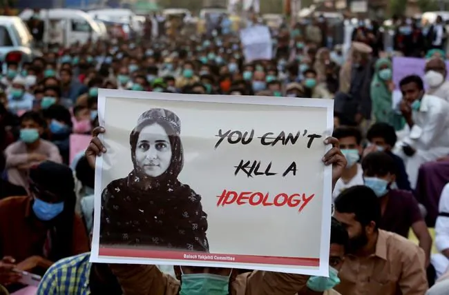 Supporters of Baloch political activist Karima Baloch hold her portrait during a demonstration to condemn her killing, in Karachi, Pakistan in this Dec. 24, 2020 file photo. (AP Photo/Fareed Khan, File)
