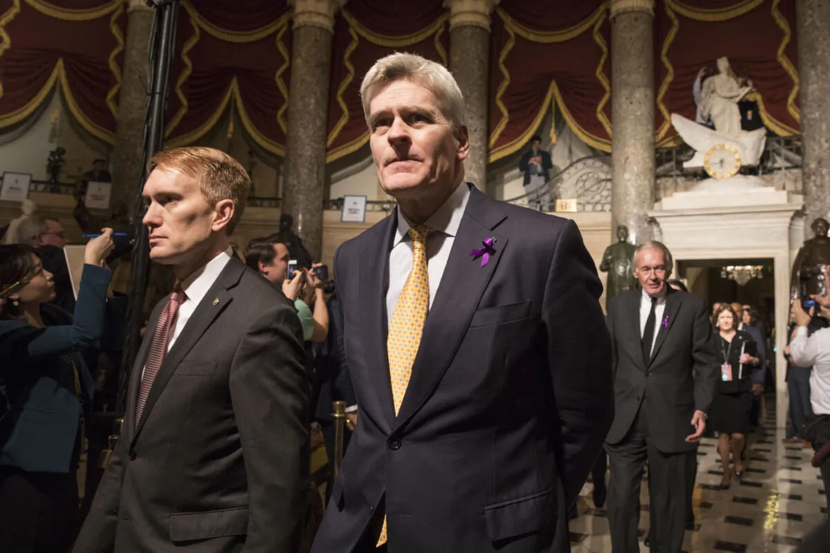 Sen. Bill Cassidy (R-La.), center, walks in the Statuary Hall of the Capitol building on the way to attending the State of the Union in Washington on Jan. 30, 2018. (Samira Bouaou/The Epoch Times)