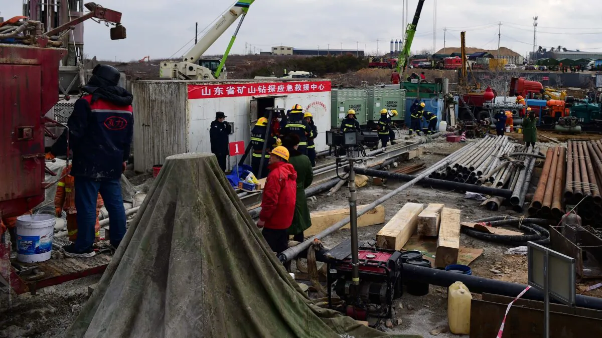 Members of a rescue team work at the site of a gold mine explosion where 22 miners are trapped underground in Qixia, in eastern China's Shandong province, on Jan. 20, 2021. (STR/AFP via Getty Images)