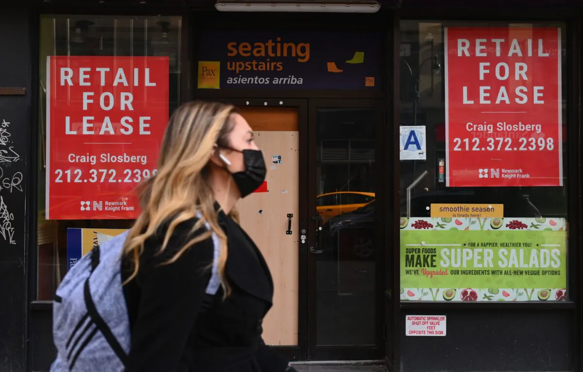 A woman walks past a closed retail store for lease in midtown Manhattan in New York City on Jan. 25, 2021. (Angela Weiss/AFP via Getty Images)