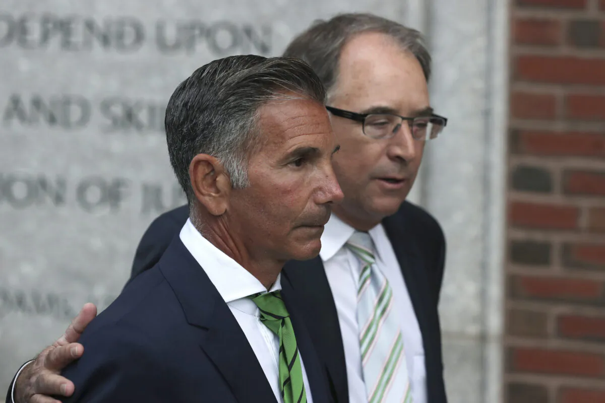Clothing designer Mossimo Giannulli, foreground, departs federal court in Boston on April 3, 2019. (Charles Krupa/AP Photo)