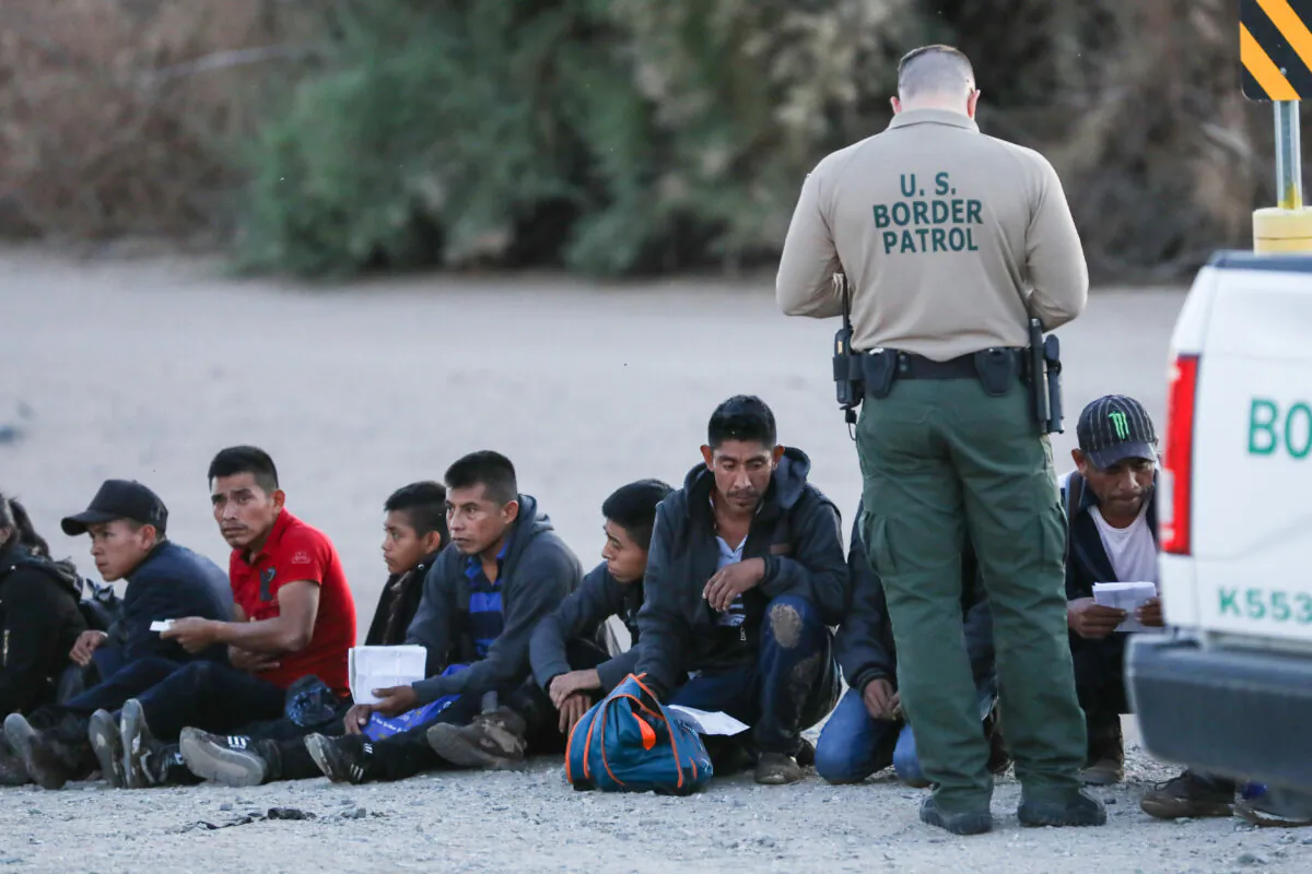 A group of illegal aliens is apprehended by Border Patrol after crossing from Mexico into Yuma, Ariz., on April 12, 2019. (Charlotte Cuthbertson/The Epoch Times)