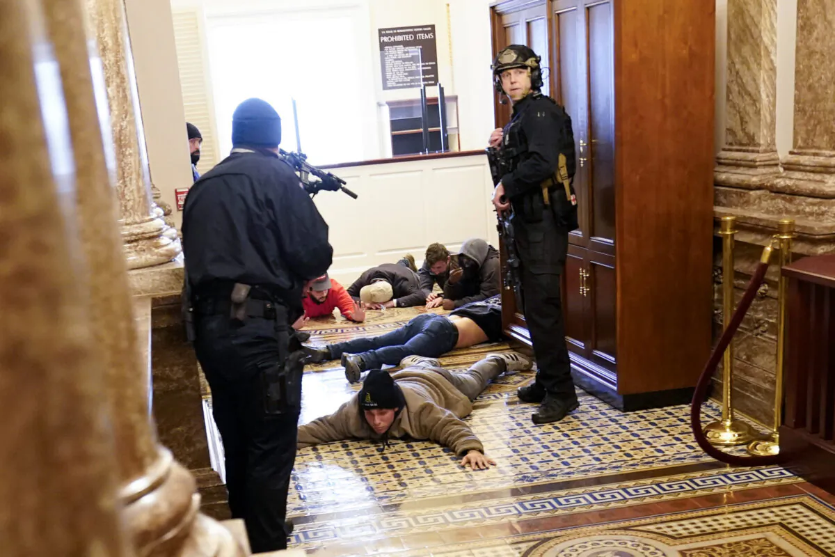 U.S. Capitol Police hold rioters at gun-point near the House Chamber inside the U.S. Capitol in Washington on Jan. 6, 2021. (Andrew Harnik/AP Photo)