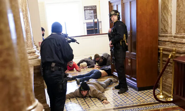 U.S. Capitol Police hold rioters at gun-point near the House Chamber inside the U.S. Capitol in Washington on Jan. 6, 2021. (Andrew Harnik/AP Photo)