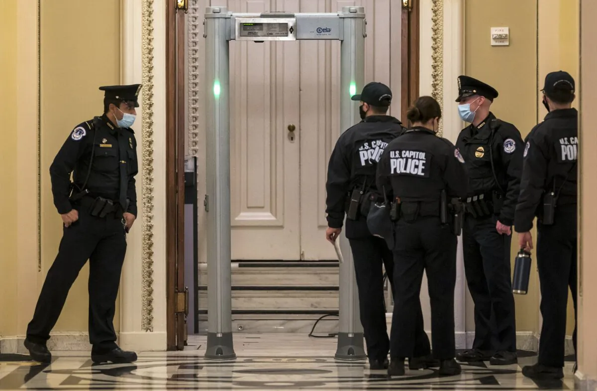 U.S. Capitol Police survey the corridor around the House of Representatives chamber after enhanced security protocols were enacted, including metal detectors for lawmakers, after protesters stormed the Capitol, in Washington on Jan. 12, 2021. (J. Scott Applewhite/AP Photo)