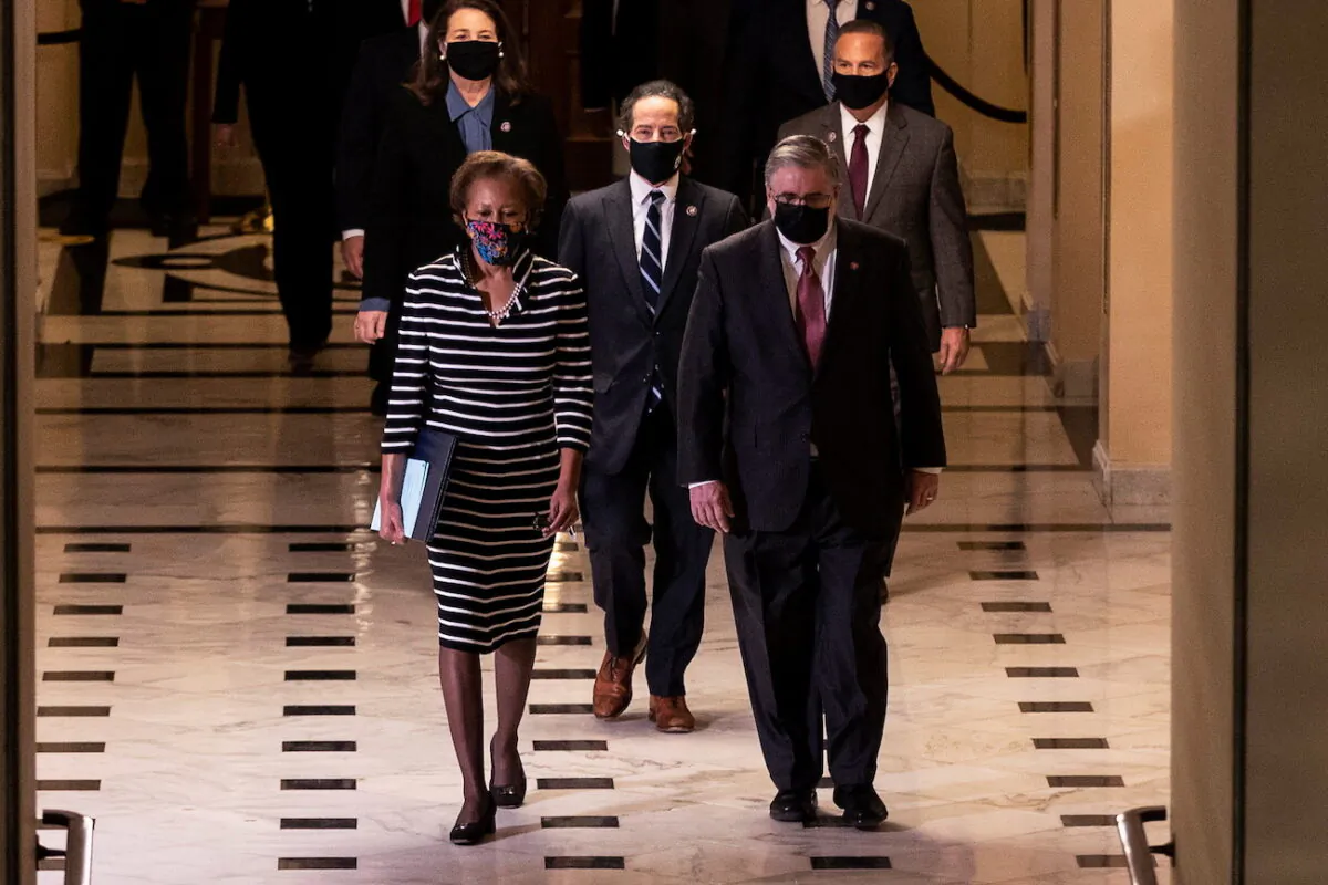 House Clerk Cheryl Johnson, Rep. Jamie Raskin (D-Md.) and Rep. David Cicilline (D-R.I.) walk through the Capitol's Statuary Hall to deliver the article of impeachment for incitement of insurrection against former President Donald Trump to the Senate floor in Washington on Jan. 25, 2021. (Tasos Katopodis/Pool/via Reuters)