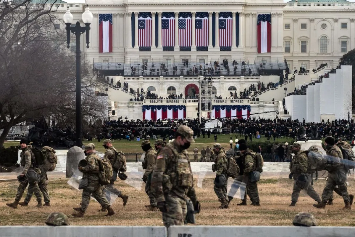 National Guard troops carry riot shields as they assume positions in the vicinity of the U.S. Capitol at the Inauguration of Joe Biden in Washington on Jan. 20, 2021. (Roberto Schmidt/AFP via Getty Images)