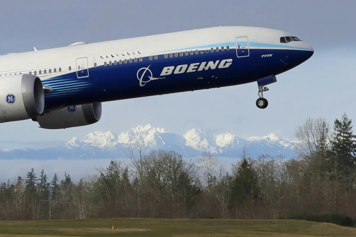 A Boeing 777X airplane takes off on its first flight with the Olympic Mountains in the background at Paine Field in Everett, Wash., on Jan 25, 2020. (Ted S. Warren/AP Photo)