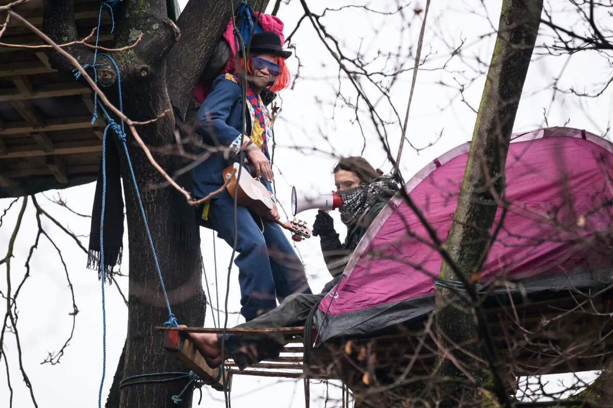 Protesters remain in their treetop positions as bailiffs and police officers attempt to clear the site of a "Stop HS2" camp at Euston Station in London on Jan. 27, 2021. (Leon Neal/Getty Images)