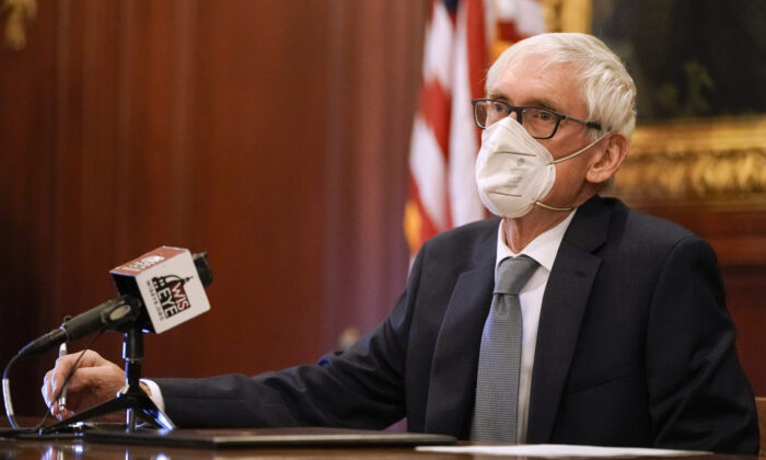 Wisconsin Gov. Tony Evers, a member of Wisconsin's Electoral College, casts his vote for the presidential election at the state Capitol in Madison, Wis., on Dec. 14, 2020. (Morry Gash-Pool/Getty Images)
