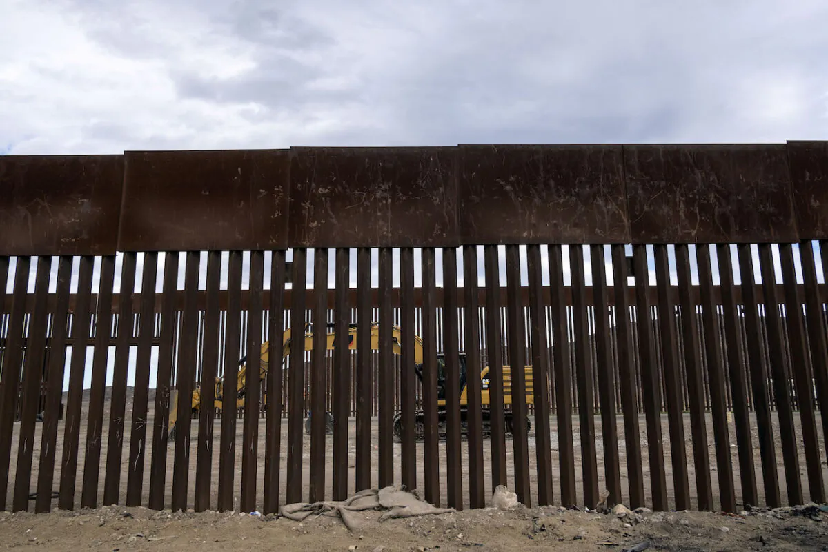A caterpillar parks between fences at a reinforced section of the U.S.-Mexico border fencing eastern Tijuana, Baja California state, Mexico on Jan. 20, 2021. (Guillermo Arias/AFP via Getty Images)