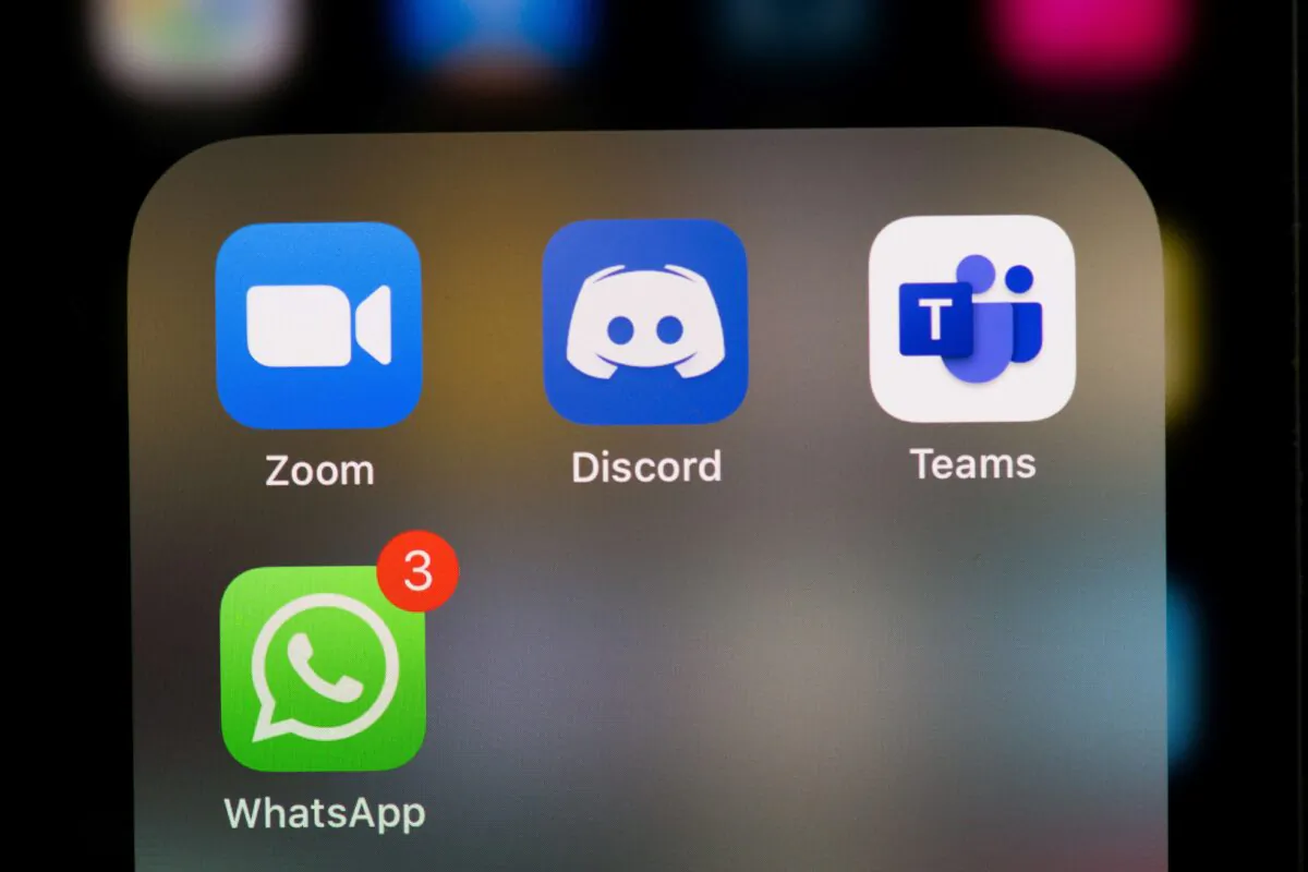 This illustration picture taken on May 27, 2020 in Paris shows the logos of the social networks  applications Zoom, Discord, Teams and WhatsApp on the screen of a phone. (MARTIN BUREAU/AFP via Getty Images)