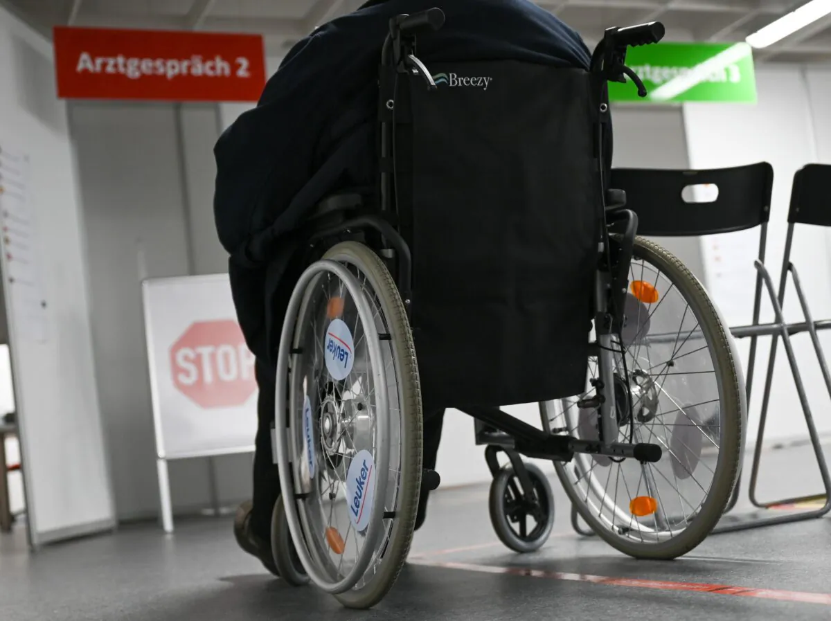 A woman in a wheelchair in Heuchelheim, Germany, on Jan. 21, 2021. (Arne Dedert/Pool/AFP via Getty Images)