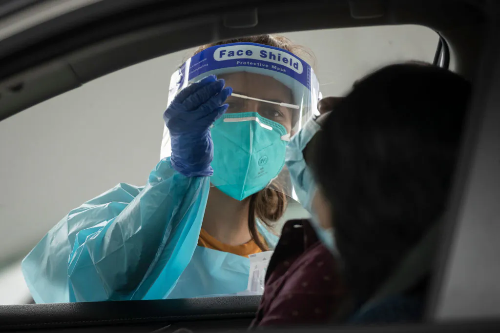 A health worker carries out a COVID-19 testing at the Merrylands drive-through clinic in Sydney, Australia, on Jan. 7, 2021. (Brook Mitchell/Getty Images)