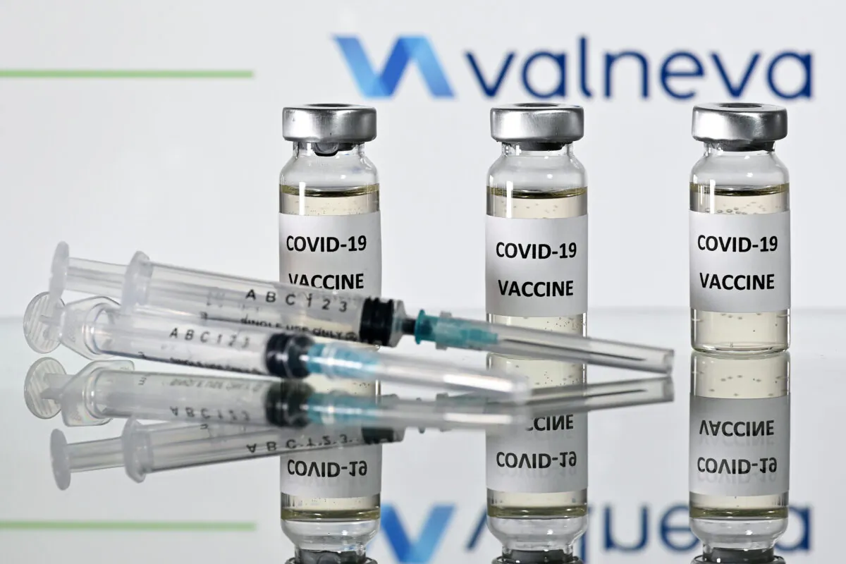 An illustration picture shows vials with COVID-19 vaccine stickers attached and syringes with the logo of French-Austrian vaccine firm Valneva on Nov. 17, 2020. (Justin Tallis/AFP via Getty Images)