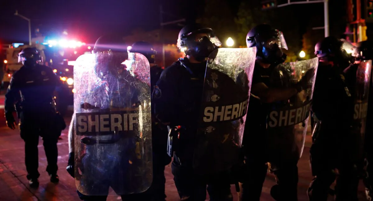 Sheriff and police in riot gear face off with protestors outside the County Courthouse during demonstrations against the shooting of Jacob Blake in Kenosha, Wis. on Aug. 25, 2020. (Kamil Krzaczynski/AFP via Getty Images)