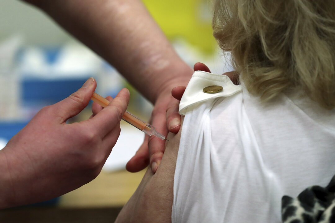 Mary Williams receives an injection of the Oxford/AstraZeneca vaccine at the mass vaccination center in Newcastle Upon Tyne, England, on Jan. 11, 2021. (Scott Heppell/AP Photo)