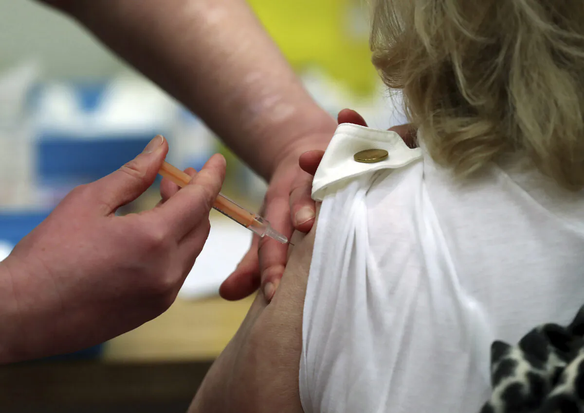 Mary Williams receives an injection of the Oxford/AstraZeneca vaccine at the mass vaccination centre in Newcastle Upon Tyne, England, on Jan. 11, 2021. (Scott Heppell/AP Photo)