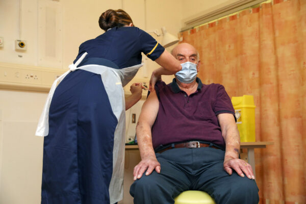 82-year-old Brian Pinker receives the Oxford University/AstraZeneca COVID-19 vaccine