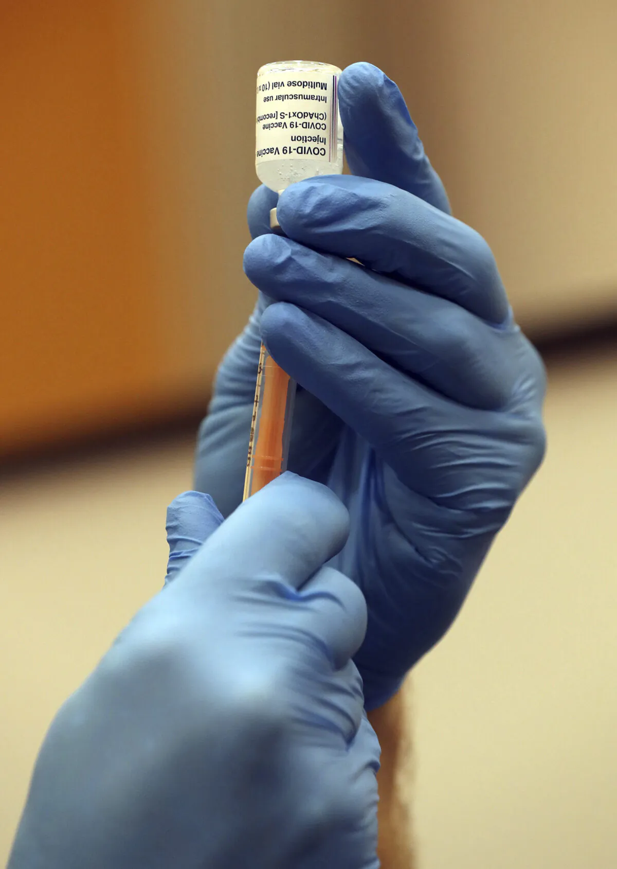 A paramedic draws a syringe of the Oxford/AstraZeneca vaccine at a mass vaccination centre in Newcastle Upon Tyne, England, on Jan. 11, 2021. (Scott Heppell/AP Photo)