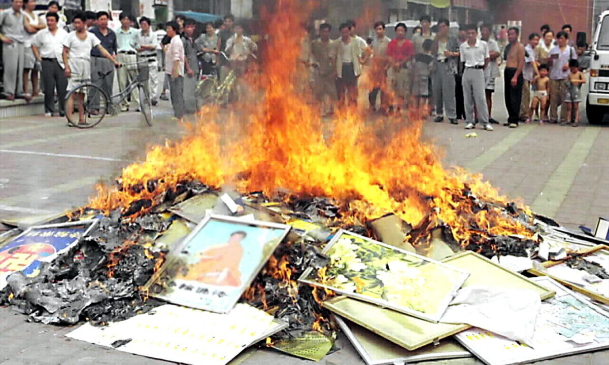 Falun Gong books are set on fire in Shouguang City, China's eastern Shandong Province, on Aug. 4, 1999. Chinese authorities in cities across China burned millions of Falun Gong books and materials after the communist regime launched a campaign to persecute the spiritual practice in July 1999. (STR/XINHUA/AFP via Getty Images)