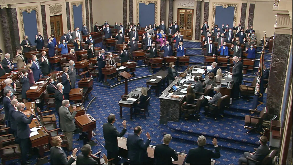 Sen. Patrick Leahy (D-Vt.) the president pro tempore of the Senate, who is presiding over the impeachment trial of former President Donald Trump, swears in members of the Senate for the impeachment trial at the U.S. Capitol in Washington on Jan. 26, 2021. (Senate Television via AP)