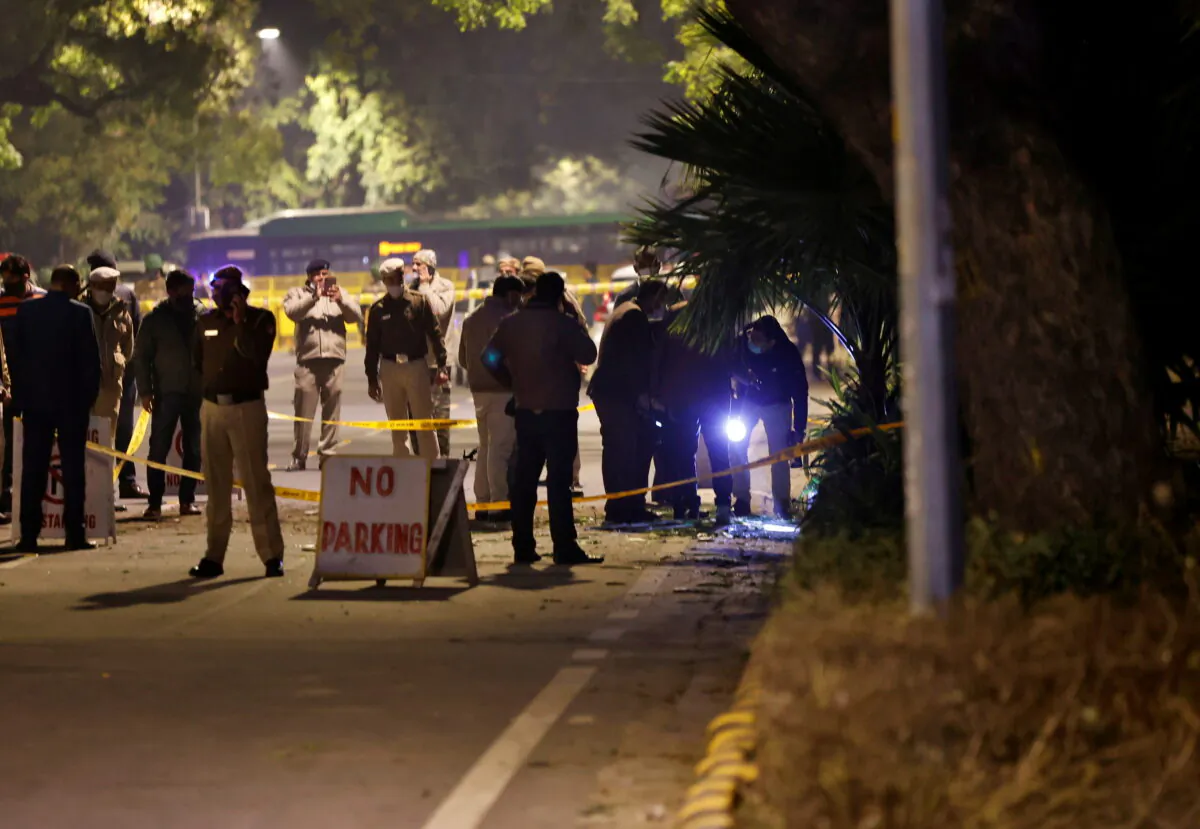 Police officials examine the site of an explosion near the Israeli Embassy in New Delhi, India, Jan. 29, 2021.  (Danish Siddiqui/Rueters)