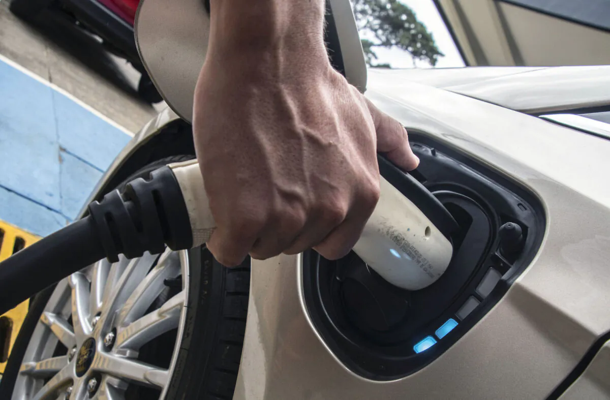 Costa Rican Roberto Quiros, owner of two electric cars, charges one of them at a Costa Rican Institute of Electricity (ICE) charging station in San Jose on Dec. 4, 2018. (Ezequiel Becerra/AFP via Getty Images)