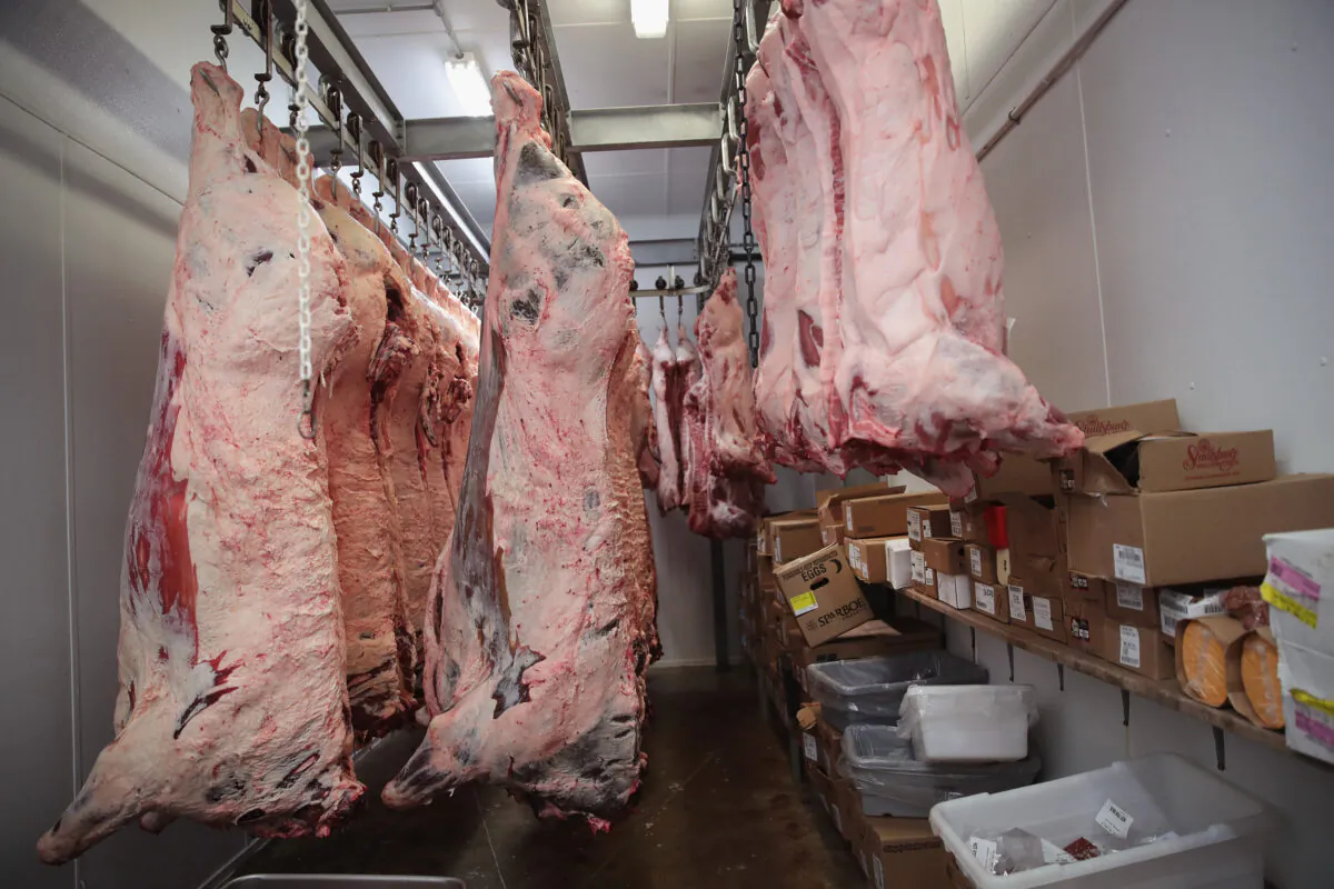 Beef and hog sides hang in the cooler awaiting processing in Elma, Iowa, on July 25, 2018. (Scott Olson/Getty Images)