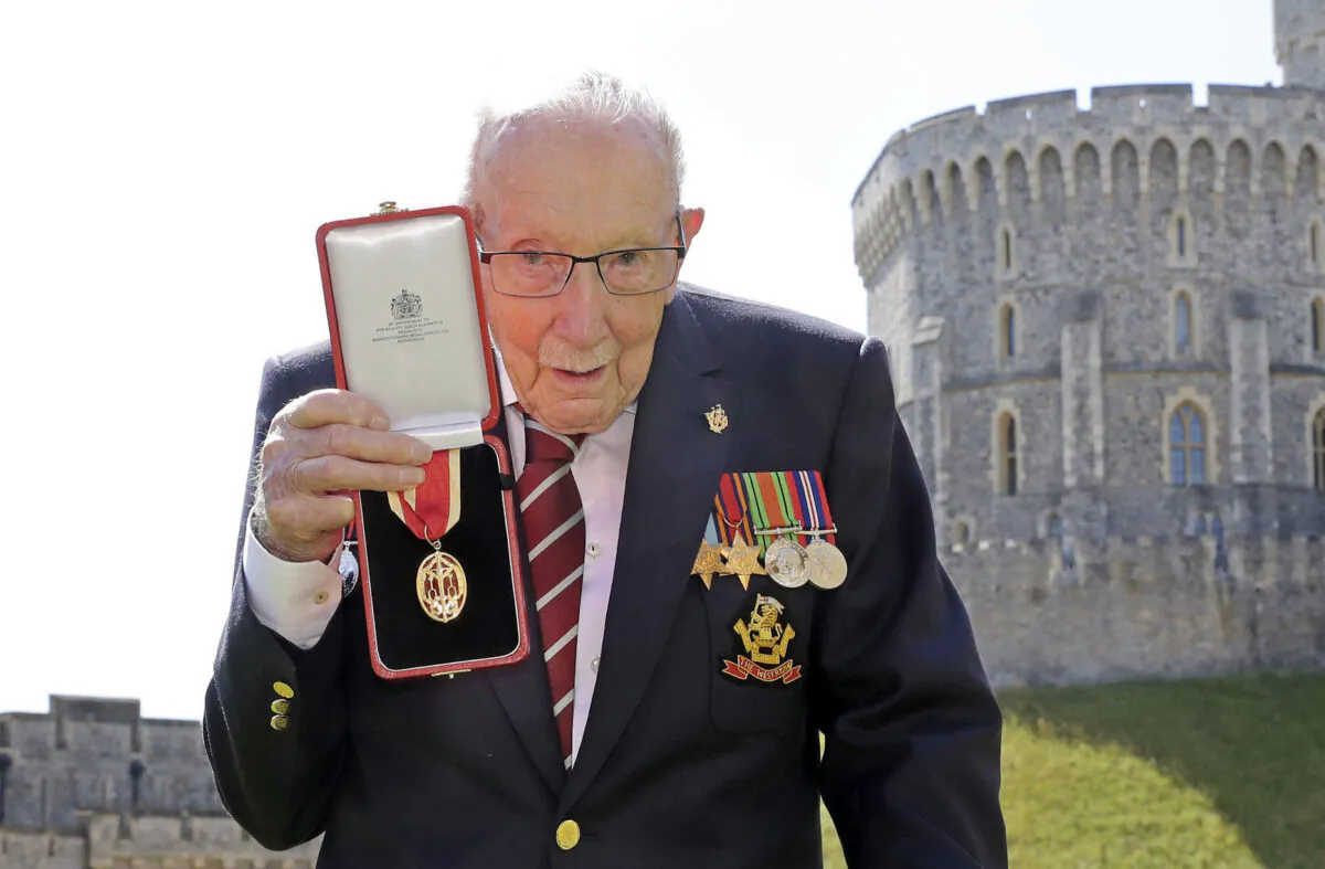 Captain Sir Thomas Moore poses for the media after receiving his knighthood from Britain's Queen Elizabeth, during a ceremony at Windsor Castle in Windsor, England, on July 17, 2020. (Chris Jackson/Pool Photo via AP, File)