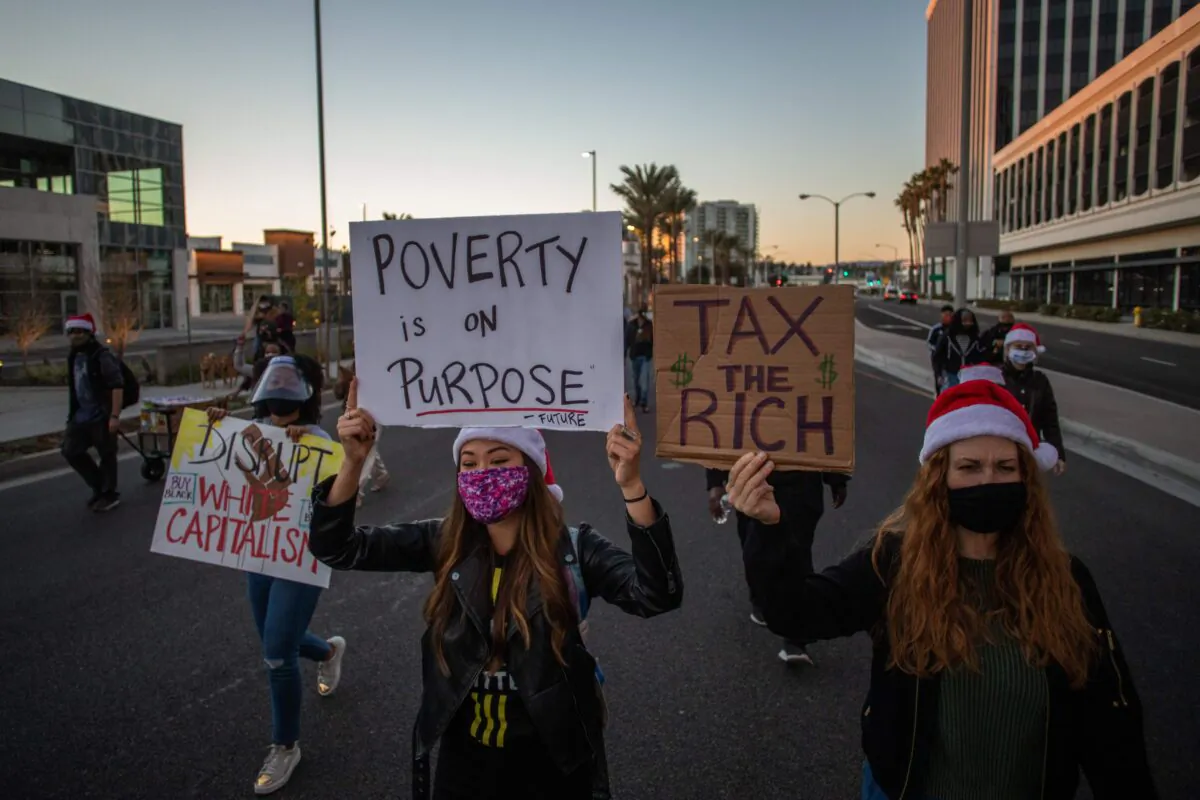 Protesters march in the Marina Del Rey neighbourhood of Los Angeles during a Black Lives Matter rally to demand social justice on December 19, 2020. (Apu GOMES / AFP) (Photo by APU GOMES/AFP via Getty Images)