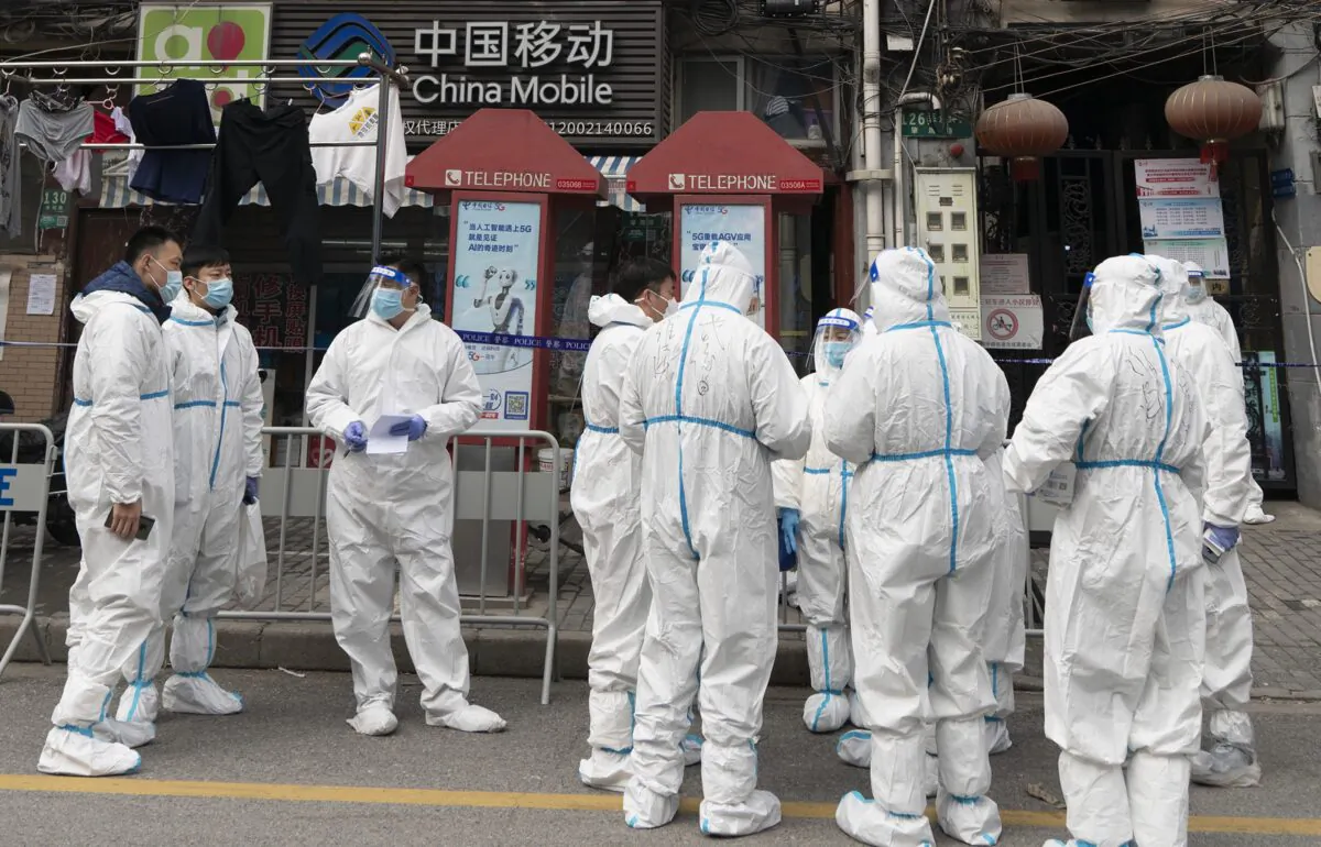 Health workers are seen in the Huangpu district in Shanghai on Jan. 28, 2021. (Hu Chengwei/Getty Images)