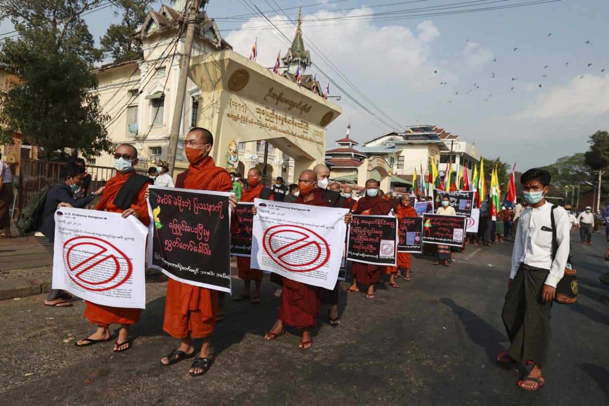 Buddhist monks hold placards