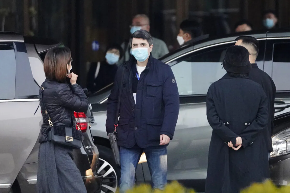 Vladmir Dedkov, center, of the World Health Organization team prepares to leave for a third day of field visit in Wuhan, China, on Jan. 31, 2021. (Ng Han Guan/AP Photo)
