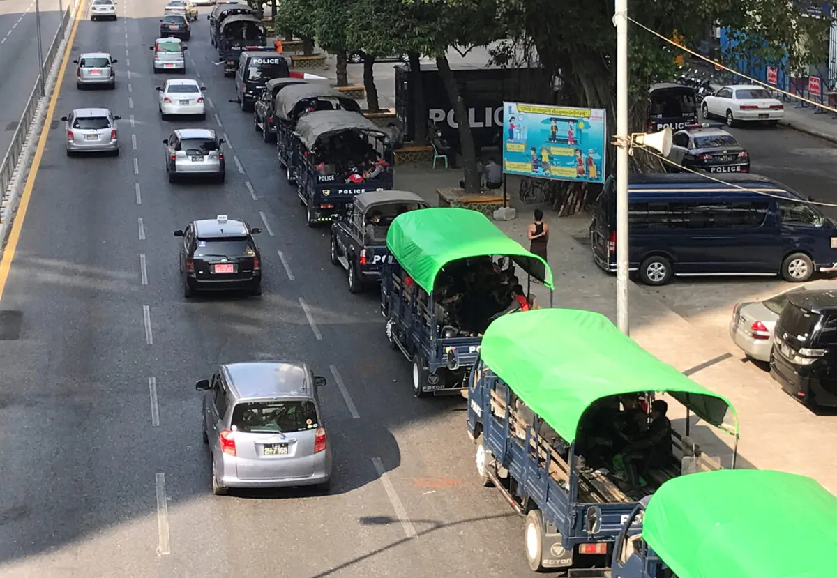 Myanmar police vehicles drive near the City Hall in Yangon, Myanmar, on Feb. 1, 2021. (Stringer/Reuters)