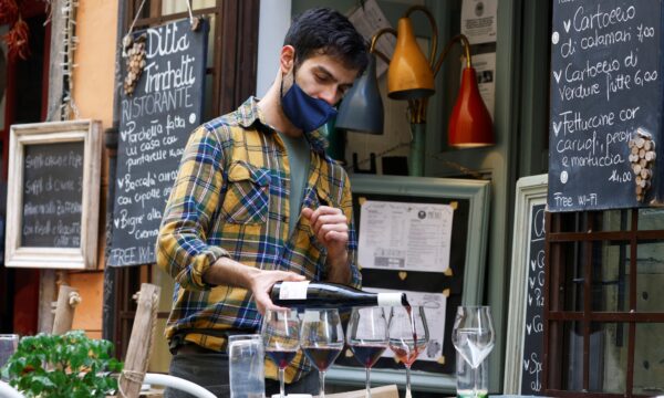 Staff member pours wine at a restaurant