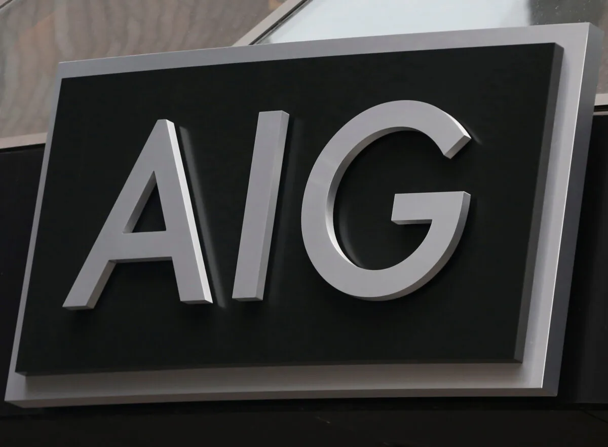 A sign is displayed over the entrance to the AIG headquarters offices at financial district in New York City, N.Y., on Jan. 9, 2013. (Brendan McDermid/Reuters)