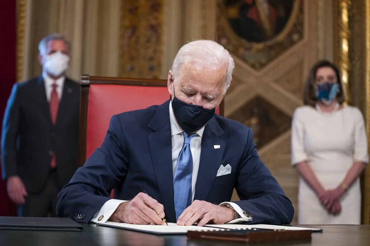 President Joe Biden signs documents including cabinet nominations and sub-cabinet nominations in the Presidents Room at the Capitol after the inauguration ceremony in Washington on Jan. 20, 2021. (Jim Lo Scalzo-Pool/Getty Images)