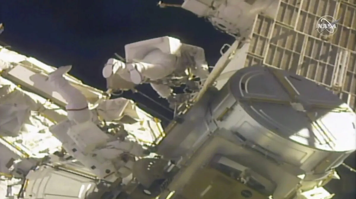 NASA astronauts Mike Hopkins (L) and Victor Glover work outside the International Space Station on Feb. 1, 2021. (NASA via AP)