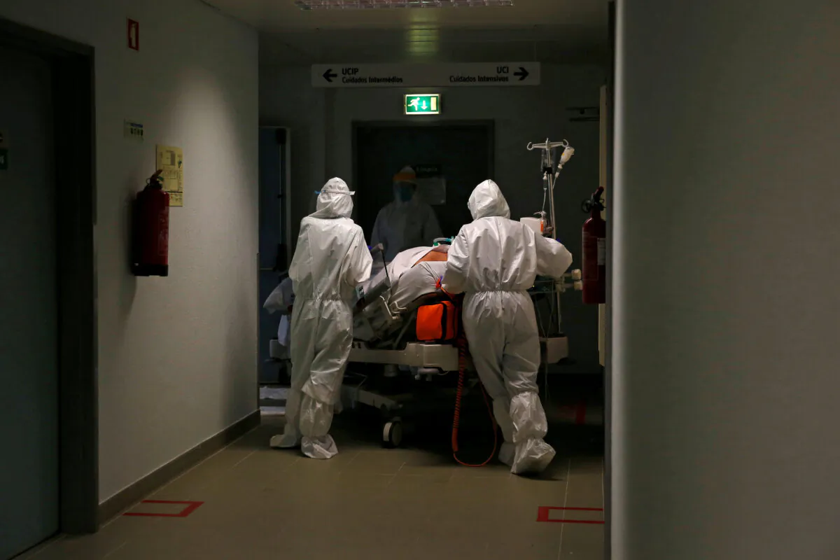 A patient is carried to the COVID-19 Intensive Care Unit (ICU) of Cascais Hospital in Cascais, Portugal, on Jan. 27, 2021. (Pedro Nunes/Reuters)