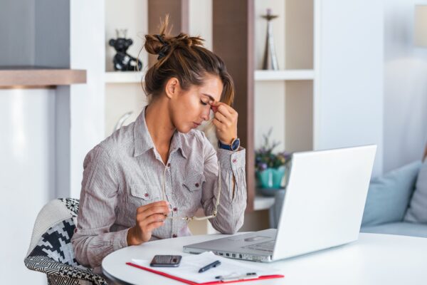 Young,Frustrated,Woman,Working,At,Office,Desk,In,Front,Of
