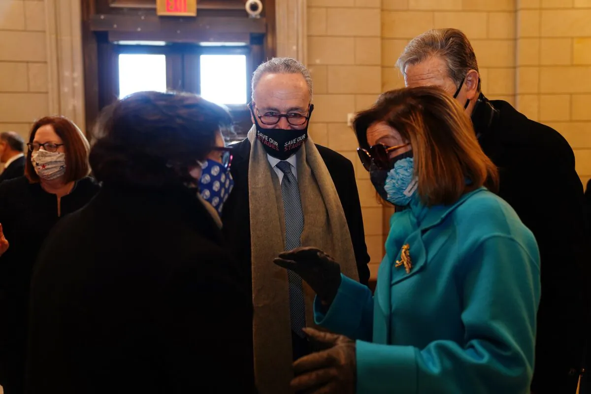 Senate Majority Leader Chuck Schumer (D-N.Y.), center, and House Speaker Nancy Pelosi (D-Calif.), second from right, are seen in Washington on Jan. 20, 2021. (Jim Lo Scalzo/Pool/Getty Images)