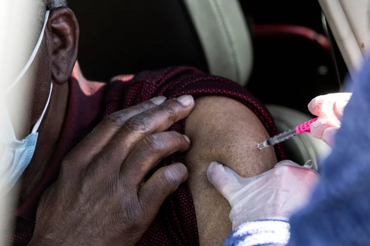 A man gets his first dose of the COVID-19 vaccine administered during mass vaccinations at Coors Field baseball stadium in Denver, Colo., on Jan. 30, 2021. (Chet Strange/AFP via Getty Images)
