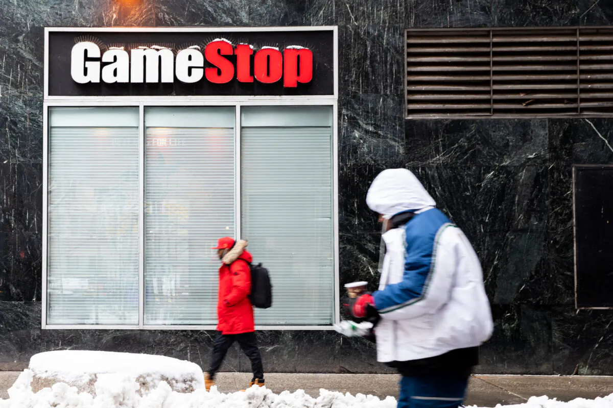 People walk past a GameStop store in New York on Feb. 2, 2021. (Chung I Ho/The Epoch Times)