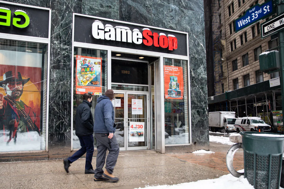 People walk past a GameStop store in New York on Feb. 2, 2021. (Chung I Ho/The Epoch Times)
