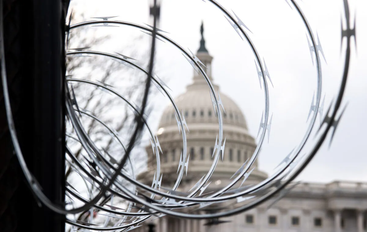 Barbed wire is installed on the top of a security fence surrounding the U.S. Capitol in Washington on Jan. 15, 2021. (Saul Loeb/AFP via Getty Images)