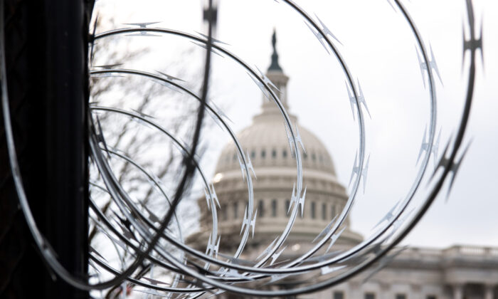 Barbed wire is installed on the top of a security fence surrounding the U.S. Capitol in Washington on Jan. 15, 2021. (Saul Loeb/AFP via Getty Images)