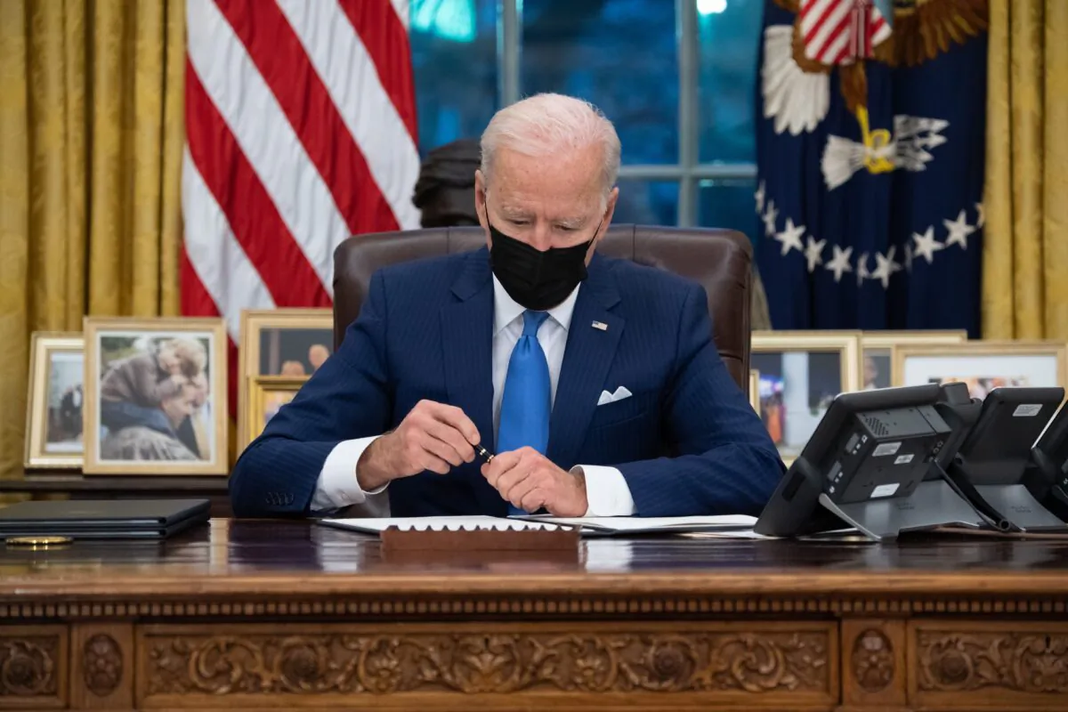 President Joe Biden signs executive orders related to immigration at the White House in Washington on Feb. 2, 2021. (Saul Loeb/AFP via Getty Images)
